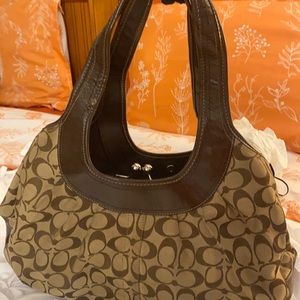 Chocolate brown patent leather Coach bag with tan embroidered Coach logo